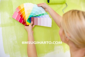 Woman with scale of paint swatches